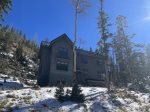 Aspen and pine flank the home on the hillside above Taos Ski Valley village.